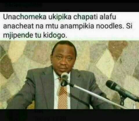 a man in a suit and tie is speaking into a microphone